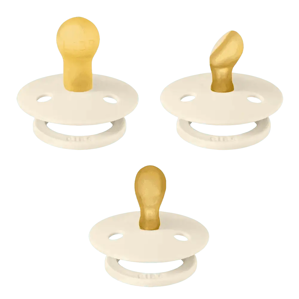 Trois sucettes BIBS Ivory aux formes de tétine différentes, vues de profil